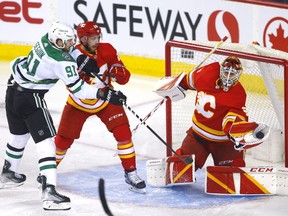 Calgary Flames goalie Jacob Markstrom makes a save against Tyler Seguin and the Dallas Stars at the Scotiabank Saddledome in Calgary on Thursday, April 21, 2022.