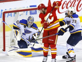 Calgary Flames forward Andrew Mangiapane is stopped by St. Louis Blues goalie Jordan Binnington at the Scotiabank Saddledome in Calgary on Jan. 24, 2022.