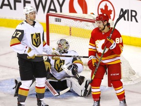 Calgary Flames forward Andrew Mangiapane celebrates after scoring on Vegas Golden Knights goalie Robin Lehner while defenceman Ben Hutton looks on at the Scotiabank Saddledome in Calgary on Feb. 9, 2022.