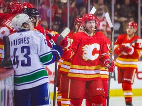 Calgary Flames centre Elias Lindholm celebrates with teammates after scoring his 40th goal of the season during a game against the Vancouver Canucks at the Scotiabank Saddledome in Calgary on Saturday, April 23, 2022.