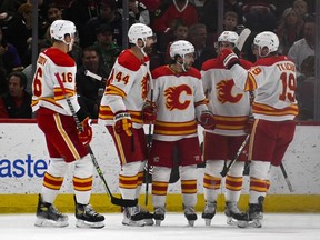 Calgary Flames forward Johnny Gaudreau (centre) celebrates his goal against the Chicago Blackhawks with teammates at United Center in Chicago on Monday, April 18, 2022.