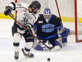The Eastman Selects' Bryce Warkentine battles South Alberta Hockey Academy goalie Brock Lott during the Mac's International Hockey Tournament at the Max Bell Center in Calgary on Wednesday, April 6, 2022.