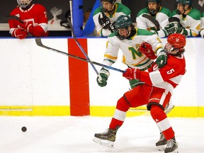 The Calgary Northstars' Mark Lafleur battles the St. George School's Hunter McInnes during the Mac's International Hockey Tournament at Max Bell Center in Calgary on Wednesday, April 6, 2022.