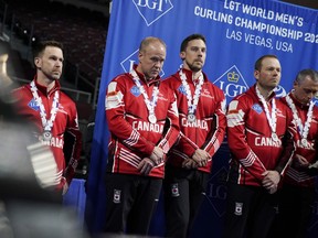 Silver-medal finishers Canada — skip Brad Gushue, third Mark Nichols, second Brett Gallant, lead Geoff Walker and fifth E.J. Harnden — stand on the podium after the World Men’s Curling Championships at Orleans Arena in Las Vegas on Sunday, April 10, 2022.