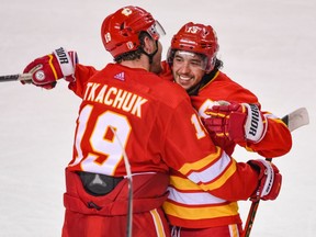 Matthew Tkachuk congratulates Johnny Gaudreau on his game-winning goal in overtime against the Dallas Stars in the deciding Game 7 of their first-round playoff series at Scotiabank Saddledome in Calgary on May 15, 2022.