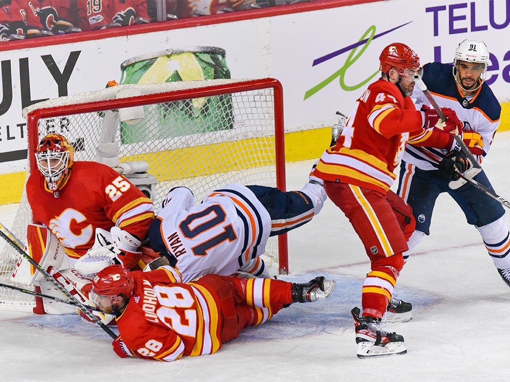 Calgary Flames Elias Lindholm and Edmonton Oilers Derek Ryan crash into each other in front of Calgary Flames goalkeeper Jacob Markstrom during the third period of the first game of the second round of playoff action at Scotiabank Saddledome on Wednesday, May 18, 2022. The Flames won 9-6. 