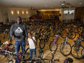 FILE PHOTO: Gar Gar and his son, Gar Jr. pose with the bicycles that have been donated in the YYC Kids Ride bicycle drive at the Forest Lawn Community Association in Calgary on Sunday, April 4, 2021.