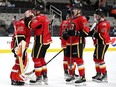 Stockton Heat defenceman Ilya Solovyov plants a smooch on the mask of goaltender Dustin Wolf after a victory.