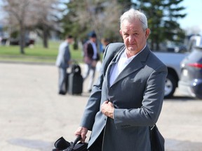 Flames head coach Darryl Sutter arrives as the team departs Calgary en route to Dallas on May 6, 2022, during their first-round playoff series with the Stars.
