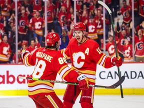 Calgary Flames center Mikael Backlund (11) celebrates his goal with left wing Andrew Mangiapane (88) during the third period against the Dallas Stars in game five of the first round of the 2022 Stanley Cup Playoffs at Scotiabank Saddledome