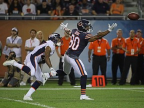 Victor Cruz #80 of the Chicago Bears reaches for a pass under pressure from Brendan Langley #27 of the Denver Broncos during a preseason game at Soldier Field on August 10, 2017 in Chicago, Illinois.