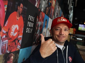 Home and Away co-owner Pete Emes was photographed next to a photo of former Calgary Flames forward Doug Gilmour in the Beltline sports bar on Thursday, May 19, 2022. Gilmour played on the 1989 Stanley Cup winning Flames team. Calgary bars and restaurants are enjoying a boost in business as the Flames continue their quest for a Stanley Cup.