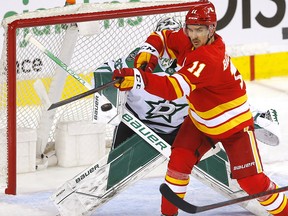 Calgary Flames Mikael Backlund battles Dallas Stars goalie Jake Oettinger in first period action during Game 7 at the Scotiabank Saddledome in Calgary on Sunday, May 15, 2022.