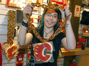 Rachael Knapkin, owner of CGY Team Store located at the Scotiabank Saddledome, shows off some of the new items and is pumped for the playoffs in Calgary on Monday, May 2, 2022.