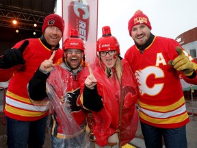 FILE PHOTO: Calgary Flames fans Ryan and Hailey McKenzie with ex-Flames L-R, Mike Commodore and Curtis Glencross brave the weather to take in the Red Lot Party as the Flames start their playoff run at the Scotiabank Saddledome in Calgary on Thursday, April 11, 2019.