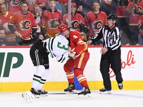 Calgary Flames defenceman Rasmus Andersson (4) fights Dallas Stars defenceman John Klingberg (3) during the first period in Game 1 of the first round of the 2022 Stanley Cup Playoffs at Scotiabank Saddledome on May 3, 2022.