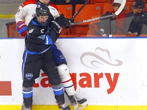 The South Alberta Hockey Academy (SAHA) Braxton Thornton battles Vancouver NE Chiefs Matthew Wise during the 2022 Mac's Tournament hockey championships at Max Bell arena in Calgary on Sunday, April 10, 2022.