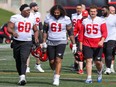 Calgary Stampeders offensive linemen, from left, Joshua Coker, Hugh Thornton and Josh Mosley during training camp at McMahon Stadium in Calgary on Sunday, May 15, 2022.