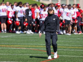 Guest coach Tara McNeil walks on the field during Calgary Stampeders training camp at McMahon Stadium. McNeil is working with the club for a four-week period during training camp, providing assistance with strength and conditioning, as part of the CFL’s Women In Football Program.