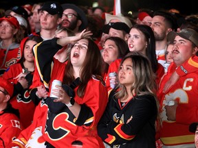 Flames fans react to the action at the outdoor viewing party outside the Saddledome on Thursday as the Dallas Stars went on to tie the series at 1-1.