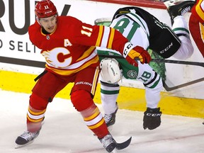 Calgary Flames Mikael Backlund battles Dallas Stars Michael Raffl in first period during round one of the Western Conference NHL playoff action at the Scotiabank Saddledome in Calgary on Tuesday, May 3, 2022.