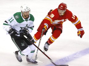 Calgary Flames forward Matthew Tkachuk battles Dallas Stars forward Luke Glendening during Game 1 of their first-round playoff series at Scotiabank Saddledome in Calgary on Tuesday, May 3, 2022.