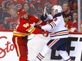 Calgary Flames defenceman Oliver Kylington battles Edmonton Oilers forward Leon Draisaitl at Scotiabank Saddledome in Calgary on March 7, 2022.