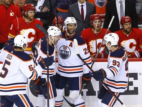 Cody Ceci, Zach Hyman, Darnell Nurse and Ryan Nugent-Hopkins celebrate Hyman’s game-winning goal during Game 2 of their second-round playoff series at Scotiabank Saddledome in Calgary on Friday, May 20, 2022.