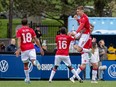 Cavalry FC’s Myer Bevan (9) celebrates with teammates during a match against HFX Wanderers FC at Wanderers Grounds in Halifax on Sunday, May 15, 2022. Bevan was awarded a goal that went in off the Wanderers’ keeper.