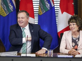 Alberta Premier Jason Kenney, left, says he will stay in the top job to maintain continuity and stability in government until a new United Conservative party leader is chosen, in Calgary, Alta., Friday, May 20, 2022.THE CANADIAN PRESS/Jeff McIntosh
