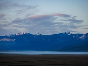 Sunrise touches the peaks above the Kootenay River valley west of Creston, B.C., on Monday, May 2, 2022.