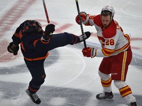 Edmonton Oilers forward Evander Kane and Calgary Flames forward Elias Lindholm collide during Game 4 of their second-round playoff series at Rogers Place in Edmonton on Tuesday, May 24, 2022.