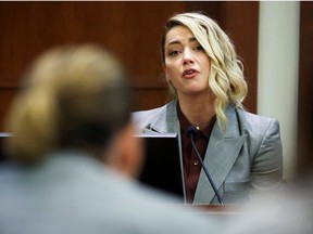 Actor Amber Heard testifies near Actor Johnny Depp during the Depp vs Heard defamation trial at the Fairfax County Circuit Court in Fairfax, Virginia, U.S. May 26, 2022.