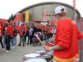 Flames fans lined up to get into the Red Lot for Game 6 watch a man playing drums before the game started.
