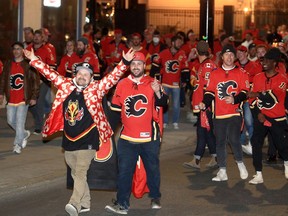 Fans celebrate on the Red Mile after the Calgary Flames shut out the visiting Dallas Stars 1-0 in Game 1 of their first-round playoff series on Tuesday. May 3, 2022.