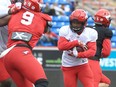 Running back Peyton Logan carries the ball during the Calgary Stampeders’ Red & White Game at McMahon Stadium on Saturday, May 21, 2022.