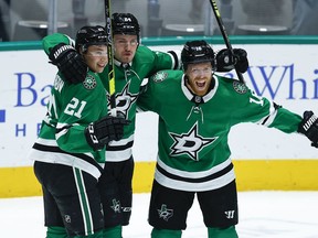 The Dallas Stars’ Joe Pavelski, right, is congratulated by Jason Robertson (21) and Roope Hintz after scoring a goal against the Seattle Kraken at American Airlines Center in Dallas on April 12, 2022.
