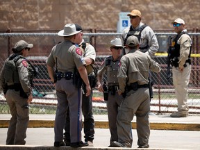 Law enforcement officers guard the scene of a shooting at Robb Elementary School in Uvalde, Texas, U.S. May 24, 2022.