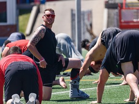 Calgary Stampeders quarterback Bo Levi Mitchell wears a foot cast while participating in a team yoga session on Friday, June 10, 2022. Mitchell suffered an ankle  during last night’s season opener against the Montreal Alouettes. on Friday, June 10, 2022.