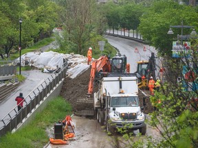 City crews construct a berm across Memorial Drive N.W. near the Bow River to protect Sunnyside against a potential flood on Tuesday, June 14, 2022.