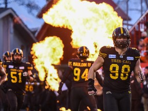 Hamilton Tiger-Cats tackle Dylan Wynn and the rest of his team charge onto the field at McMahon Stadium against the Winnipeg Blue Bombers during the Grey Cup in this photo from November 2019.