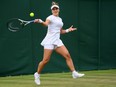 Bianca Andreescu of Canada plays a forehand against Elena Rybakina of Kazakhstan during their Women's Singles Second Round match on day four of The Championships Wimbledon 2022 at All England Lawn Tennis and Croquet Club on June 30, 2022 in London, England.