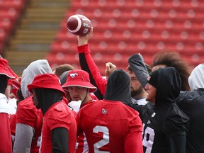 Calgary Stampeders players gather at midfield during practice at McMahon Stadium in Calgary on Friday, June 24, 2022.