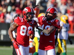 Calgary Stampeders quarterback Bo Levi and receiver Kamar Jorden celebrate after the team scored a touchdown against the Edmonton Elks at McMahon Stadium in Calgary on Saturday, June 25, 2022.