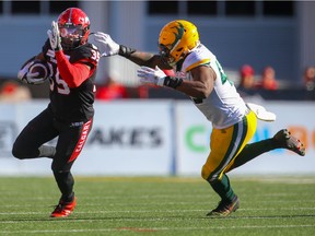 Calgary Stampeders running back Ka’Deem Carey avoids a tackle by Edmonton Elks linebacker Nyles Morgan at McMahon Stadium in Calgary during the Labour Day Classic on Sept. 6, 2021.