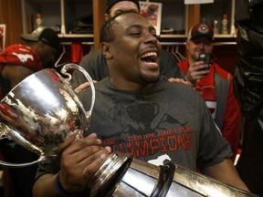 Receiver Nik Lewis celebrates with the Grey Cup after the Calgary Stampeders defeated the Hamilton Tiger-Cats at BC Place in Vancouver on Nov. 30, 2014.