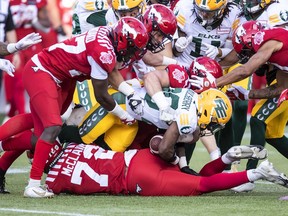 Calgary Stampeders tackle Edmonton Elks receiver Christian Saulsberry during their pre season game at Commonwealth Stadium in Edmonton on Friday, June 3, 2022.