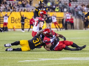 Calgary Stampeders' Jameer Thurman intercepts the ball intended for Hamilton Tiger-Cats' Sean Thomas Erlington to win the game in overtime in CFL football action in Hamilton, Ont., Saturday, June 18, 2022.