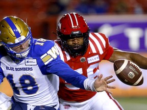 Calgary Stampeders linebacker Jameer Thurman causes a fumble in his pursuit of Winnipeg Blue Bombers QB Dru Brown during CFL action at McMahon Stadium in this photo from November 2021.