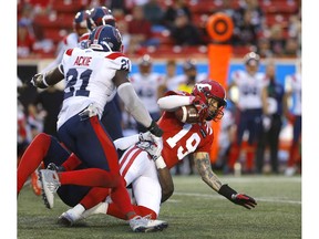 Stampeders QB Bo Levi Mitchell gets hauled down in the second half of Thursday night's CFL season-opener at McMahon Stadium in Calgary.